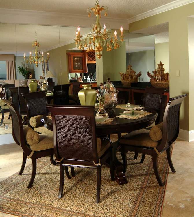 Dining room table against a mirror wall
